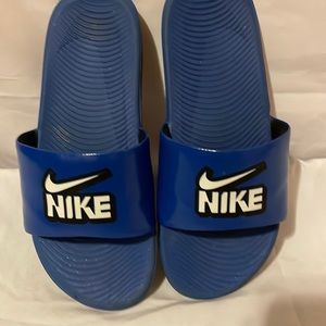Blue Nike slides.